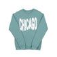 Sage green sweatshirt with 'CHICAGO' printed in white bouncy letters on a white background