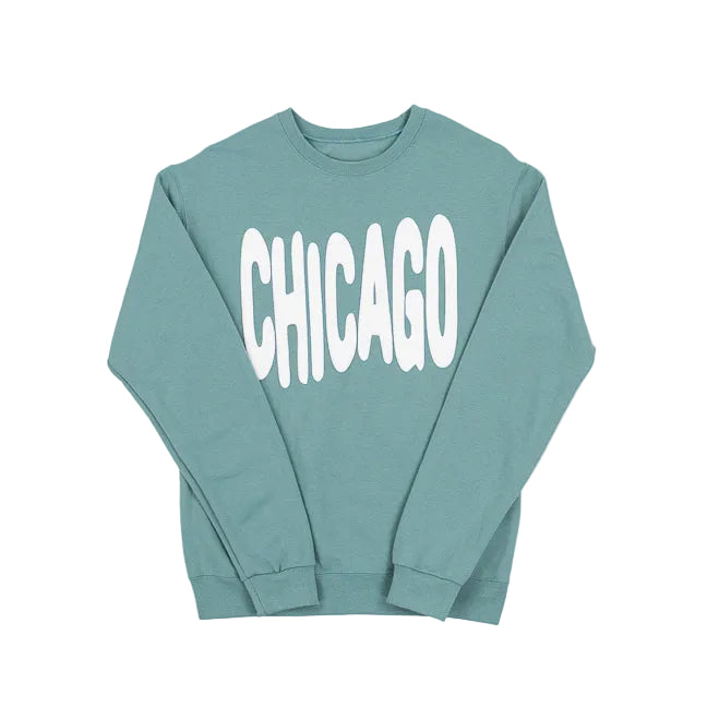 Sage green sweatshirt with 'CHICAGO' printed in white bouncy letters on a white background