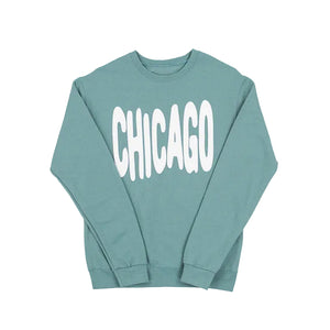 Sage green sweatshirt with 'CHICAGO' printed in white bouncy letters on a white background