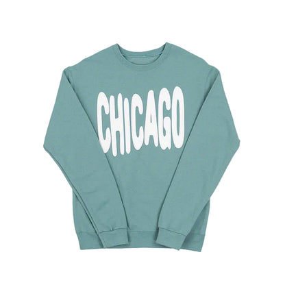 Sage green sweatshirt with 'CHICAGO' printed in white bouncy letters on a white background