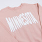 Pink sweatshirt with 'MINNESOTA' printed in white on a white background
