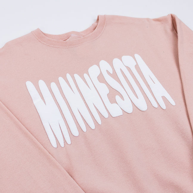 Pink sweatshirt with 'MINNESOTA' printed in white on a white background