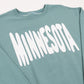 Teal sweatshirt with 'MINNESOTA' printed in white bouncy letters across the front on a white background
