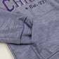Close-up of a purple sweatshirt with text on a white background