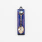 Silver spoon in a blue and white packaging on a white background