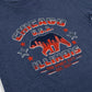 Navy blue t-shirt with red and white graphic design featuring a bear and text on a plain background.