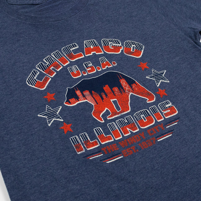 Navy blue t-shirt with red and white graphic design featuring a bear and text on a plain background.