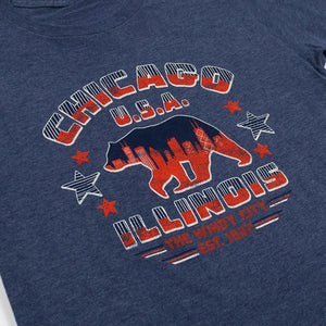 Navy blue t-shirt with red and white graphic design featuring a bear and text on a plain background.