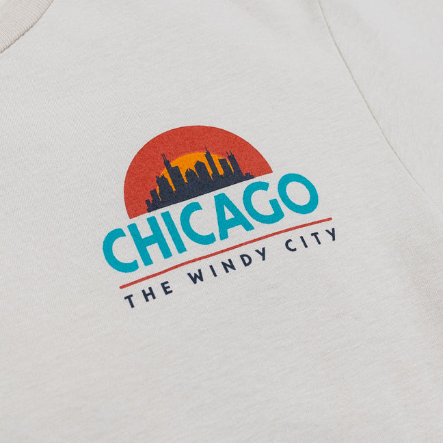 Chicago skyline logo on a beige background