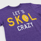 A close-up of a heather purple t-shirt featuring a distressed graphic that reads 'LET'S SKOL CRAZY' in white and yellow, with a football graphic inside the letter O.