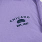 Design of CHICAGO EST 1837 and the Bean in navy against a purple shirt.