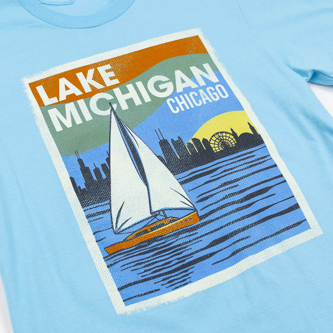Light blue t-shirt with a graphic of Lake Michigan and Chicago skyline on a white background
