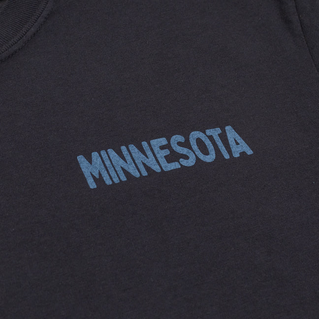 Text 'MINNESOTA' embroidered on a dark fabric background