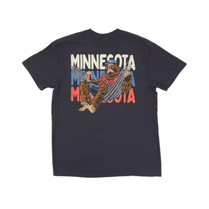 Graphite colored t-shirt with a graphic of bigfoot lying in a hammock and holding a beer on a white background