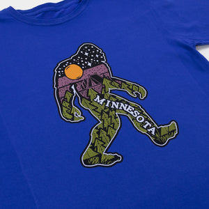 Blue t-shirt with a graphic of a stylized bigfoot and 'Minnesota' text.