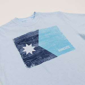 Light blue t-shirt with a star and rectangle design on a beige background