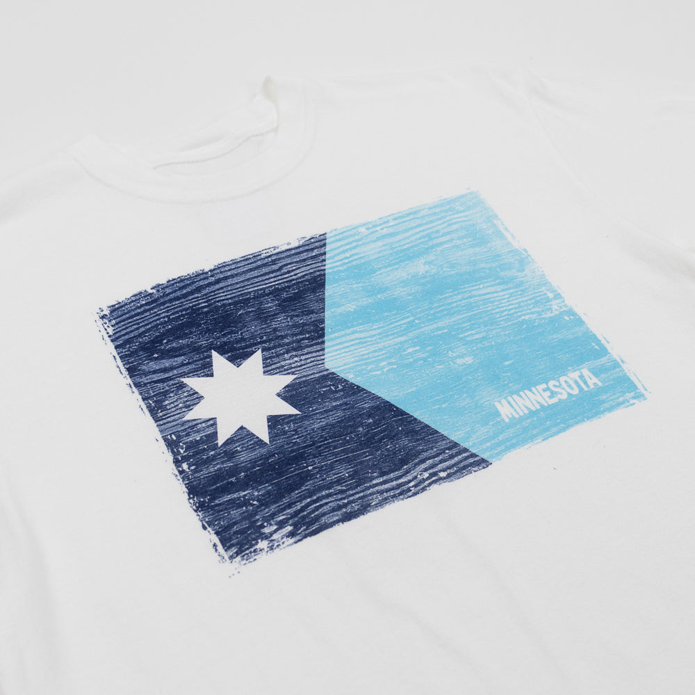 White t-shirt with a blue and white graphic design of the new Minnesota state flag and 'Minnesota' text on a white background.