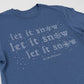 Blue t-shirt with 'let it snow' text and snowflake graphics on a light gray background