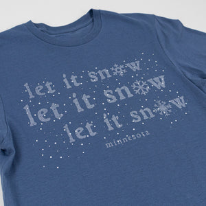 Blue t-shirt with 'let it snow' text and snowflake graphics on a light gray background