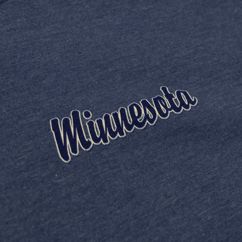 Text 'Minnesota' embroidered on a blue fabric background