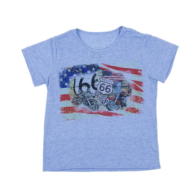 Denim blue t-shirt featuring a USA and Route 66 design on the front including motorcycles and Route 66 highway signs. set against a white backdrop.