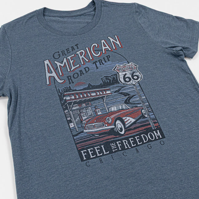 Steel Blue t-shirt with a graphic of a classic car and Route 66 sign, featuring text 'Great American Road Trip, Feel the Freedom, Chicago' on a white background.