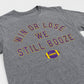Graphite gray t-shirt with purple and yellow text that reads "Win or Lose We Still Booze" with a football, set against a white background.