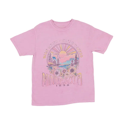Pink t-shirt with a floral scene graphic design on a white background