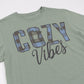 Green t-shirt with 'Cozy Vibes' text on a white background