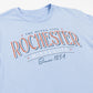 Light blue t-shirt with 'Rochester The Queen City Minnesota Since 1854' text on a white background