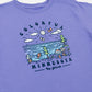 Purple t-shirt with a colorful graphic design of nature elements and 'Colorful Minnesota Up North' text.