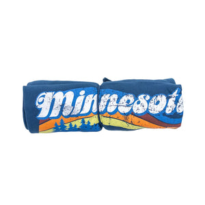 A rolled-up blanket with a Minnesota design against a white background.